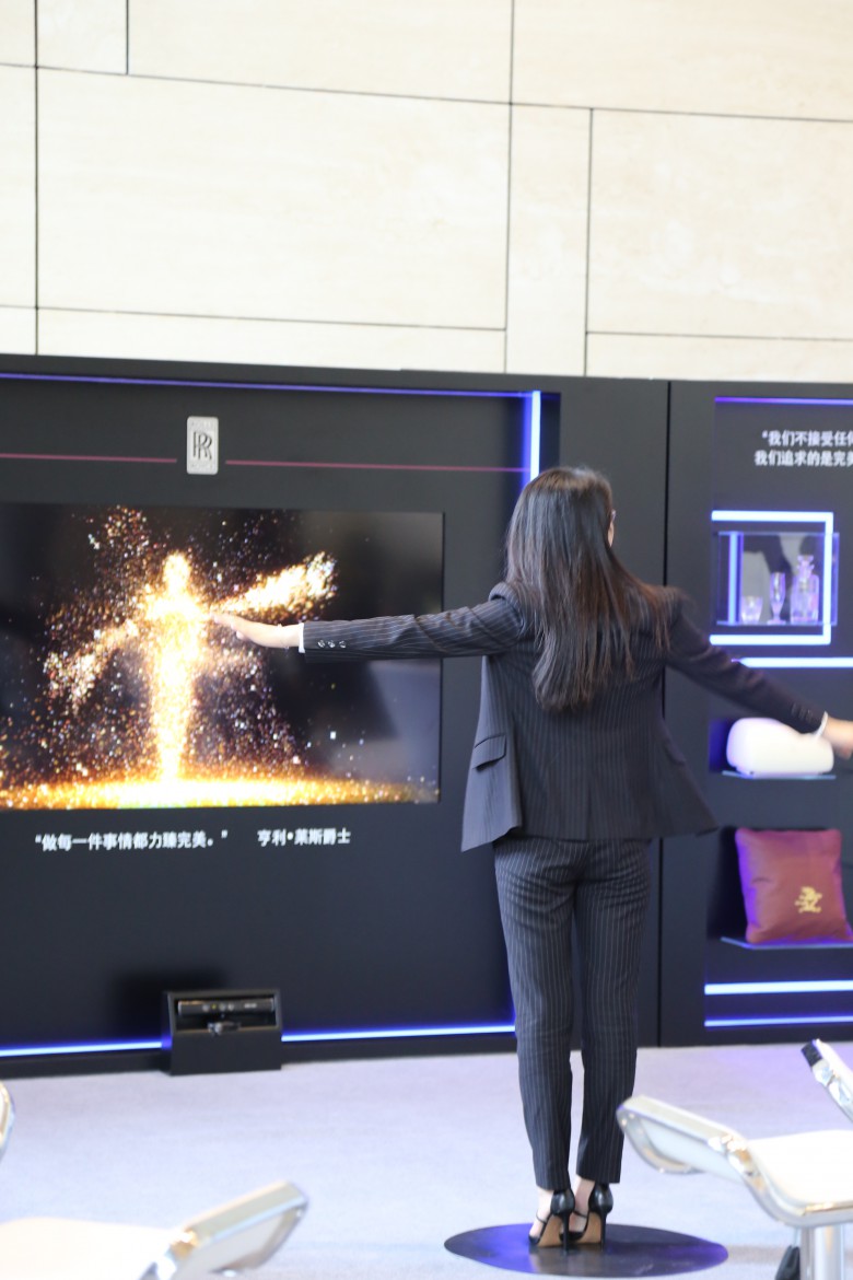 A guest interacting with the special lighting panel at the Rolls-Royce Masterpeice Series Exhibition